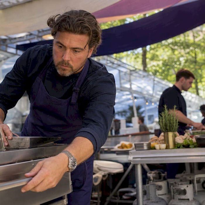 Chef preparing outdoor catering kitchen setup