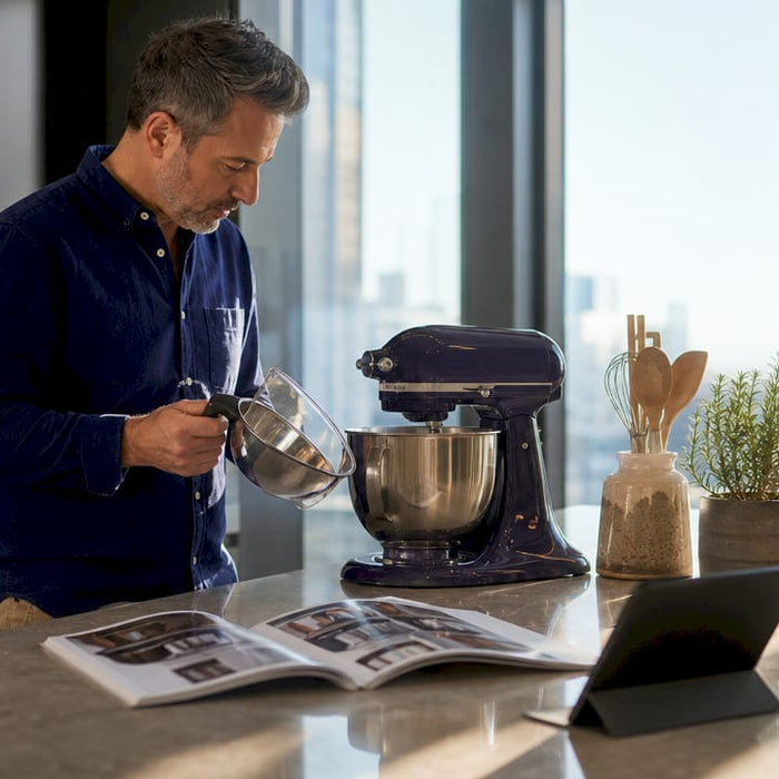 Man comparing kitchen stand mixer alternatives on countertop