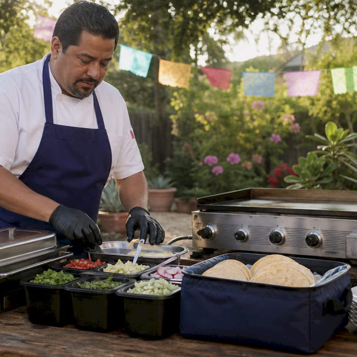 Chef setting up outdoor taco bar station