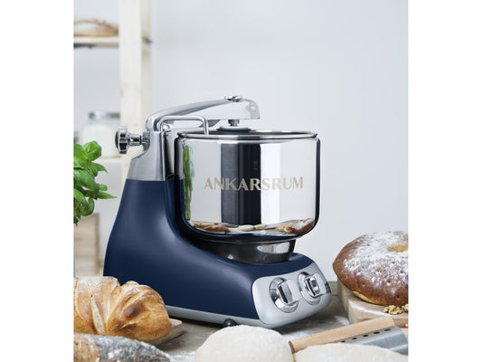Ankarsrum Assistent Original in Royal Blue surrounded by fresh baked bread