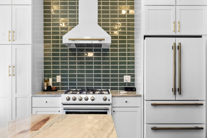 FORNO Espresso white range and refrigerator with Antique Brass accents in a kitchen