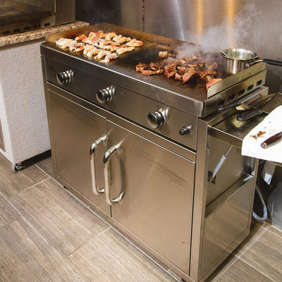 Stainless steel grill with food cooking on a tiled floor